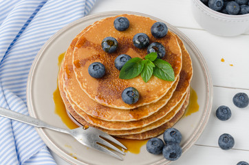 Stack of pancakes with fresh blueberry and caramel syrup