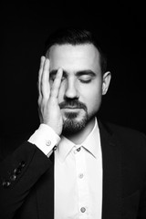  Attractive man covered his face with his hand.