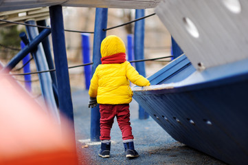 Cute little boy having fun on outdoor playground