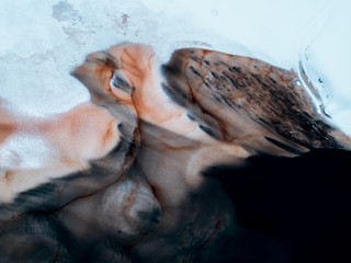 Aerial view of abstract shapes and forms created by newfly formed ice on black watered river