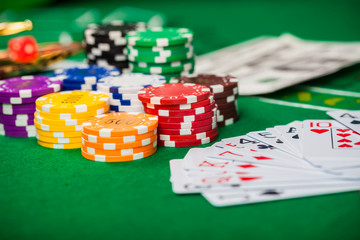 Poker chips on table in casino. Cards on green felt casino table