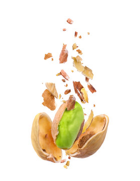 Chopped pistachio frozen in the air on a white background