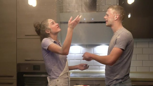  young couple flinging flour