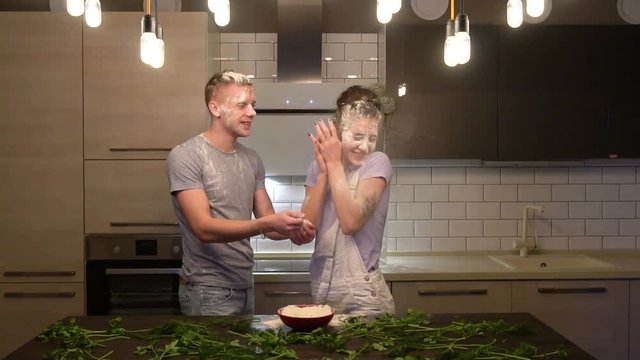 young couple flinging flour