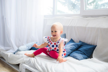 Fototapeta premium Portrait of a pretty smilling little baby girl at home