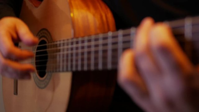 4k Musician plays by acoustic classic guitar in sound record studio