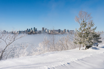 Montreal, CA - 1 January 2018: Montreal Skyline in winter as ice fog rises off the St. Lawrence...