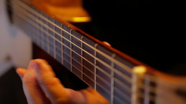 4k Man musician plays jazz music by acoustic guitar at studio travel short close-up