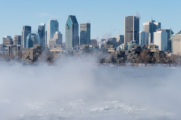 Montreal, CA - 1 January 2018: Montreal Skyline in winter as ice fog rises off the St. Lawrence River