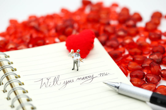Miniature people: Couple and valentine decorations character with copy space using as background valentine day, Love couple concept
