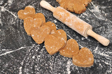 Homemade hearts cookies on a black background 
