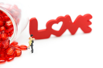 Miniature people: Couple and valentine decorations character with copy space using as background valentine day, Love couple concept