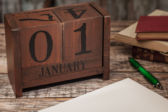 Perpetual Calendar in desk scene with blank diary page, January 1st