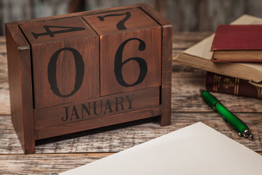 Perpetual Calendar in desk scene with blank diary page, January 6th