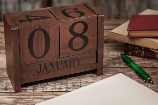 Perpetual Calendar in desk scene with blank diary page, January 8th