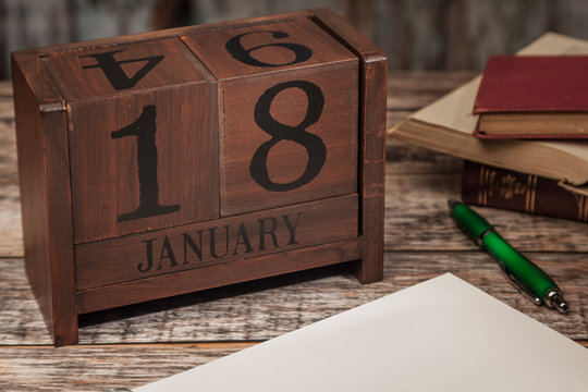 Perpetual Calendar in desk scene with blank diary page, January 18th
