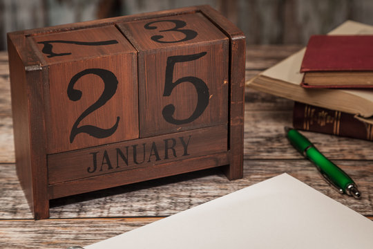 Perpetual Calendar in desk scene with blank diary page, January 25th