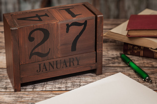 Perpetual Calendar in desk scene with blank diary page, January 27th