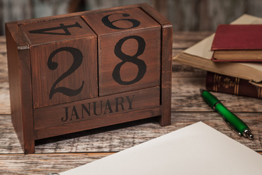 Perpetual Calendar in desk scene with blank diary page, January 28th