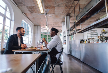 Restaurant manager talking with a professional chef