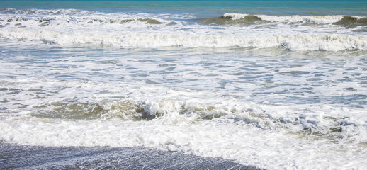 Close up image of waves coming in on Otaki Beach on the Kapiti Coast of New Zealand.