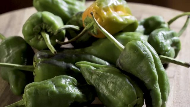 Closeup of dry padron peppers slowly turning for the camera.