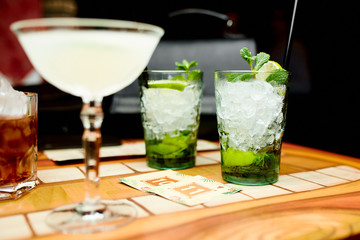 Two cocktails with lime and ice