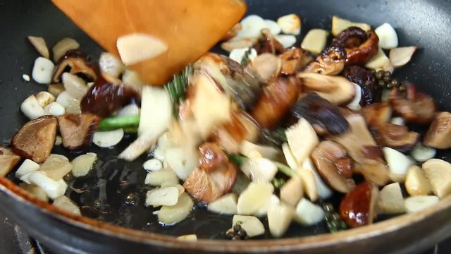 Frying  ginger shiitake and celery root  in pan