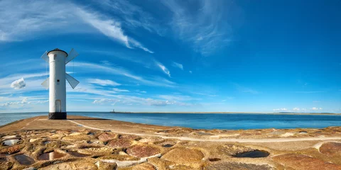 Wall murals Lighthouse Panoramic image of an old lighthouse in Swinoujscie, a port in Poland on the Baltic Sea