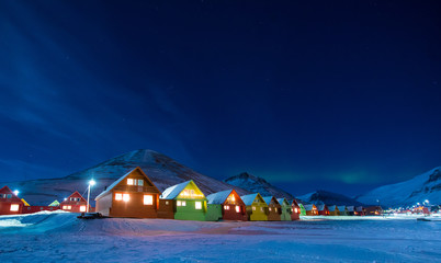 The polar arctic Northern lights aurora borealis sky star in Norway Svalbard in Longyearbyen the moon mountains