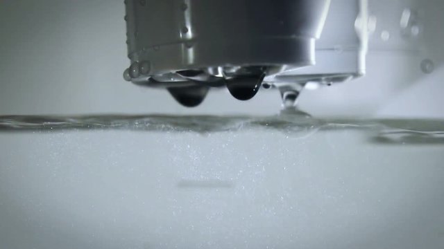 Purification of water using water filter close up. Slow motion