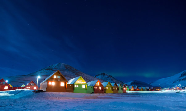 The polar arctic Northern lights aurora borealis sky star in Norway Svalbard in Longyearbyen the moon mountains