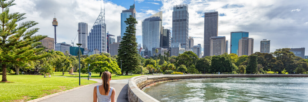 Sydney city Australia travel panorama banner. Landscape horizontal header of australian skyscrapers with person walking in park with skyline in the background. People urban lifestyle.