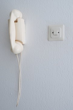 Old analogue telephone on a wall, The Hague 2017