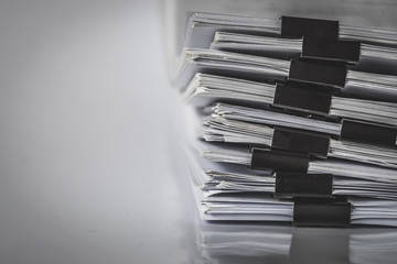 the extreamely close up  report paper stacking of office working document , retro color tone