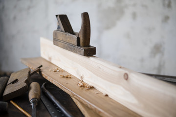 Wood planer and shavings at carpenters workshop. Joiner's tools.