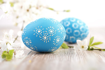 Closeup on blue Easter eggs with flowers on wood