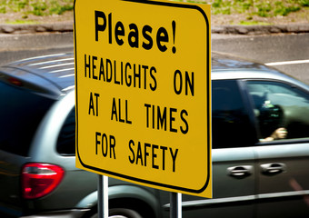 Dangerous Road Headlights on for Safety Sign