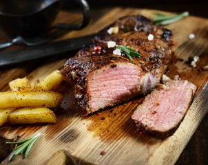 grilled juicy steak with rosemary.
