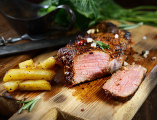 grilled juicy steak with rosemary.
