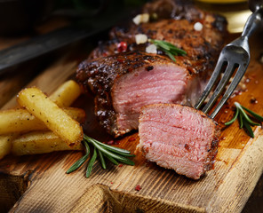 grilled juicy steak with rosemary.