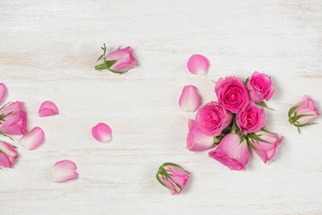 Valentine's Day greeting card with rose flowers over wooden background. Top view with copy space