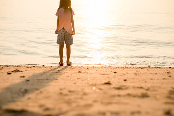 travel background girl stand alone on beach looking beautiful sea sunset. image for person, nature, portrait, landscape, scenery, evening concept