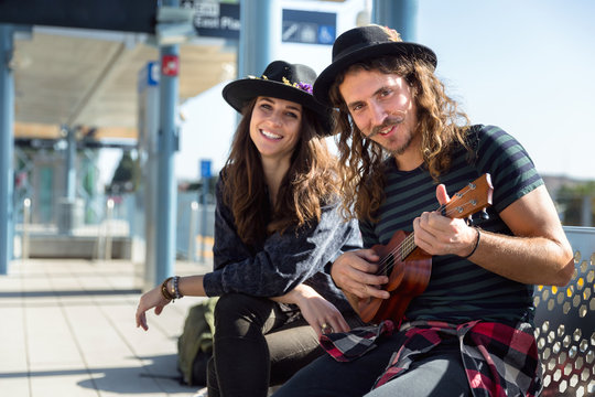 Fun Eccentric Bohemian Traveler Couple At The Metro Station Before Next Journey