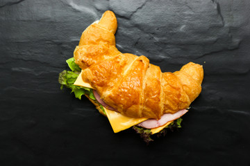 Croissant Ham cheese on black floor 