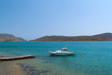 Fototapeta na wymiar Boat on the blue lagoon of Crete, Greece