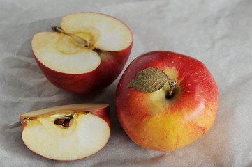 whole and sliced yellow ripe red Apple with leaf
