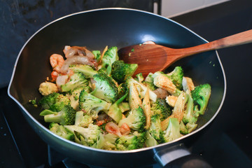 Fried broccoli with prawns in pan 