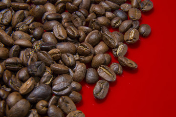 Roasted Coffee Beans red background macro close up image for coffee background.