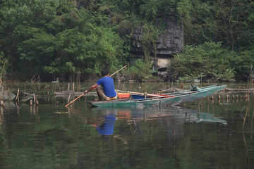 Fisherman in Tam Coc river, Vietnam.